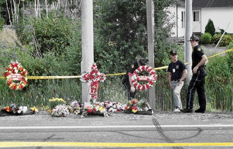 A roadside memorial is set up on the side of Highway 69 in Sudbury, Ontario.
