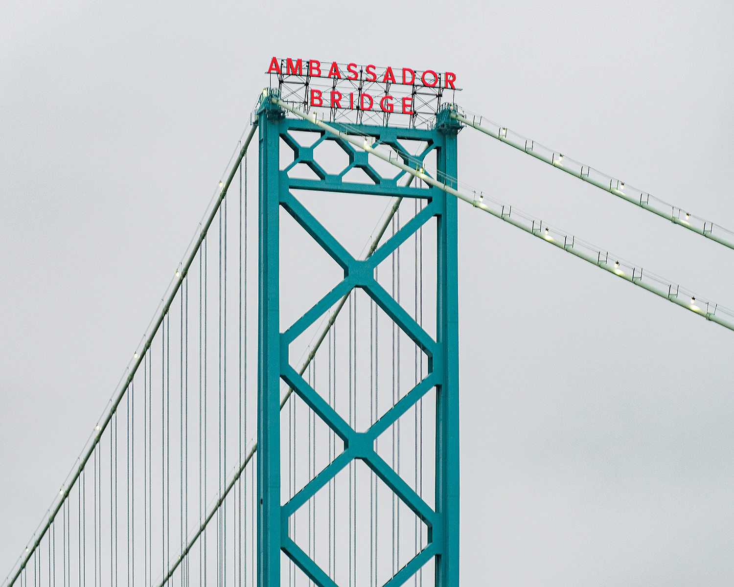 Suspension bridge’s name lit on cloudy day
