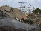 Rescuers contact some workers alive in the rubble of a deadly building
collapse in South Africa